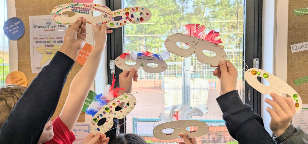 Children enjoying French class with creative masks